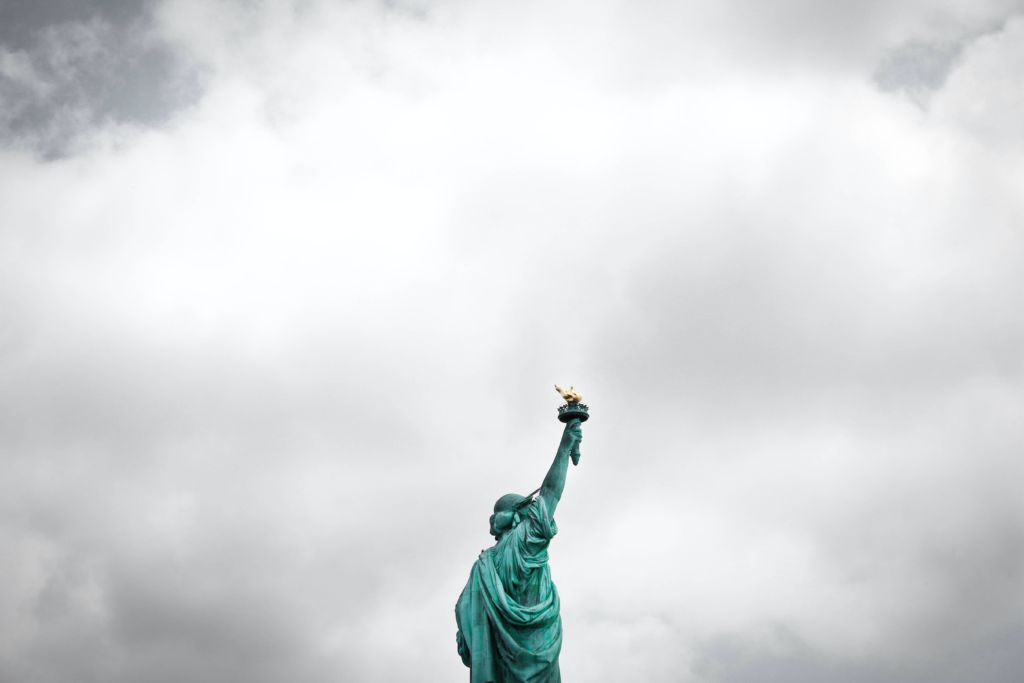 The Statue of Liberty against a cloudy sky.