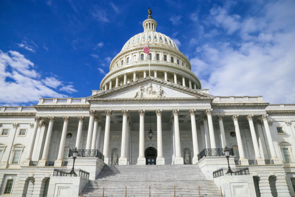 U.S. Capitol building against blue sky.