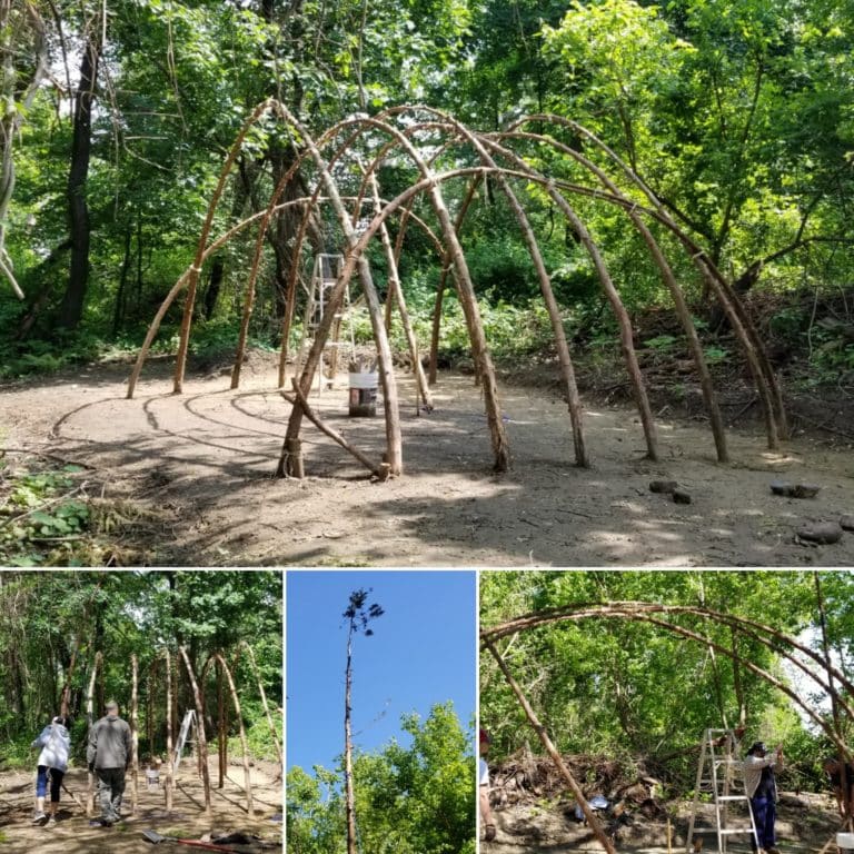 A structure made of small tree trunks built in a dome shape.