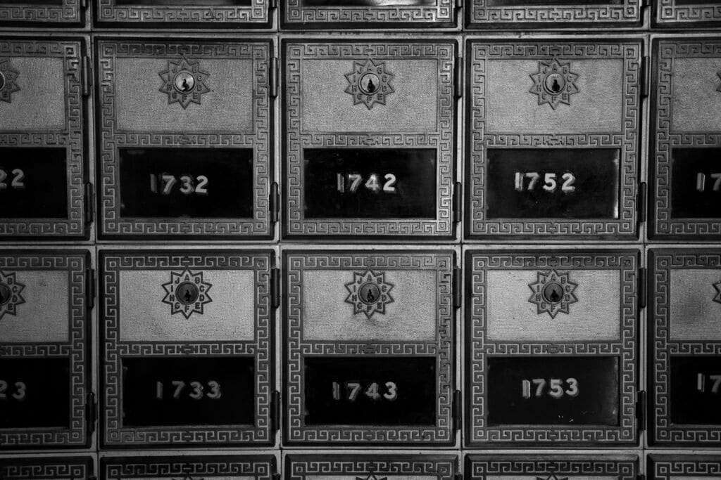 Black and white image of post office boxes.